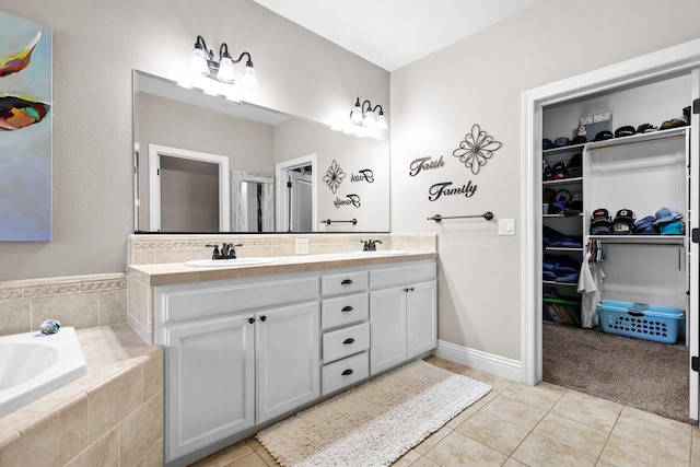 22540 Brady Ct, Red Bluff, CA 96080 - bathroom with tile patterned flooring, double vanity, a garden tub, and a walk in closet