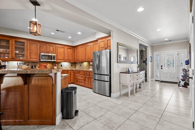 22540 Brady Ct, Red Bluff, CA 96080 - kitchen featuring stainless steel appliances, brown cabinets, a breakfast bar area, backsplash, and light tile patterned floors