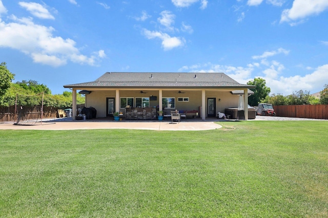 22540 Brady Ct, Red Bluff, CA 96080 - back of house featuring a ceiling fan, a patio area, stucco siding, and a hot tub