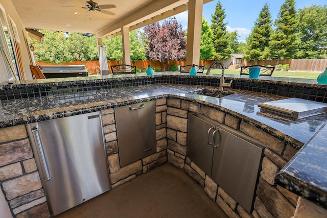 22540 Brady Ct, Red Bluff, CA 96080 - fenced backyard featuring area for grilling, a ceiling fan, a sink, and a patio