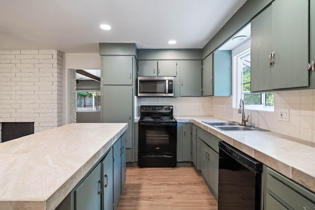 1640 Wisconsin Ave, Redding, CA 96001 - kitchen featuring black appliances, a sink, decorative backsplash, light countertops, and recessed lighting