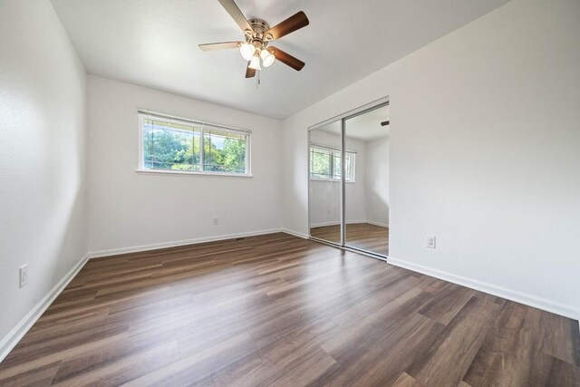 1640 Wisconsin Ave, Redding, CA 96001 - unfurnished bedroom featuring a closet, dark wood-style flooring, baseboards, and ceiling fan