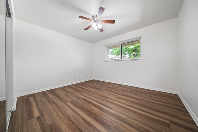 1640 Wisconsin Ave, Redding, CA 96001 - unfurnished room with dark wood finished floors, a ceiling fan, and baseboards