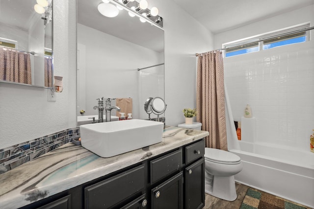 910 Montcrest Dr, Redding, CA 96003 - bathroom featuring vanity, wood finished floors, shower / bath combination with curtain, toilet, and decorative backsplash