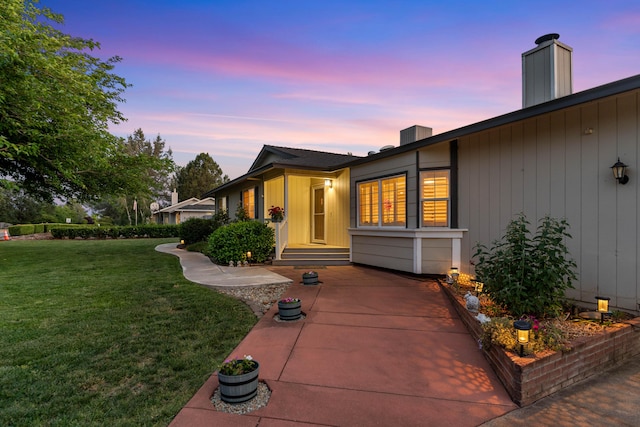 6766 Drake Dr, Anderson, CA 96007 - property exterior at dusk with a lawn and a chimney
