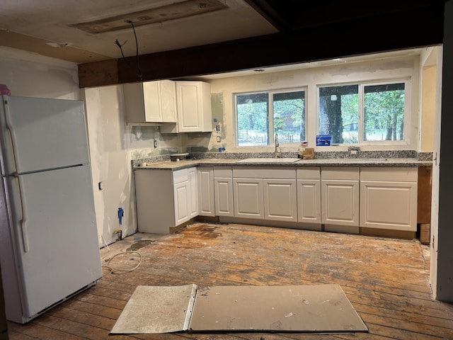 10473 Blue Mountain Ranch Rd, Whitmore, CA 96096 - kitchen featuring freestanding refrigerator, a sink, white cabinets, light countertops, and wood-type flooring