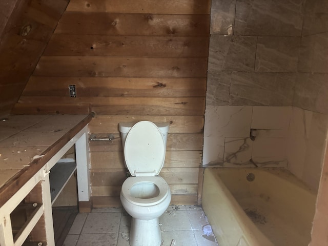 10473 Blue Mountain Ranch Rd, Whitmore, CA 96096 - full bathroom with toilet, a bath, tile patterned flooring, and wood walls
