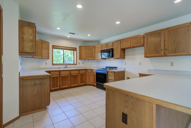 1922 Paris Ave, Redding, CA 96001 - kitchen with gas range, black microwave, a sink, brown cabinets, and recessed lighting