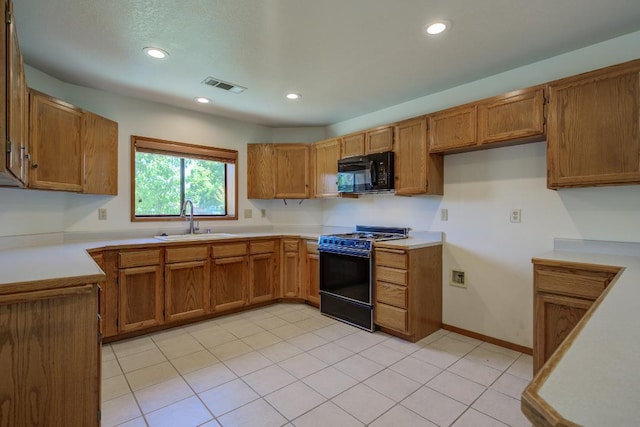 1922 Paris Ave, Redding, CA 96001 - kitchen featuring range with gas cooktop, black microwave, a sink, brown cabinetry, and recessed lighting