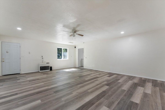 9279 Thatcher Mill Rd, Shingletown, CA 96088 - unfurnished living room with a ceiling fan, wood finished floors, recessed lighting, baseboards, and heating unit