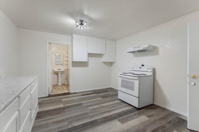 9279 Thatcher Mill Rd, Shingletown, CA 96088 - kitchen with white range with electric stovetop, under cabinet range hood, white cabinetry, light wood-type flooring, and baseboards