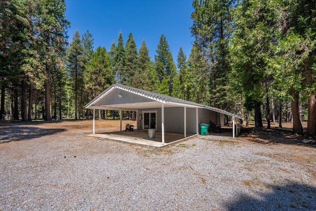9279 Thatcher Mill Rd, Shingletown, CA 96088 - view of parking / parking lot with a carport, a wooded view, and driveway