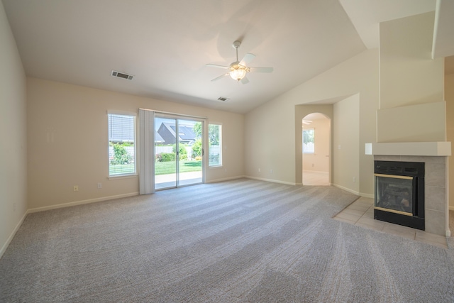 2184 Darsha Ln, Redding, CA 96003 - unfurnished living room featuring a ceiling fan, healthy amount of natural light, a tile fireplace, light carpet, and vaulted ceiling