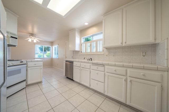 2184 Darsha Ln, Redding, CA 96003 - kitchen featuring white appliances, tile countertops, backsplash, light tile patterned floors, and ceiling fan
