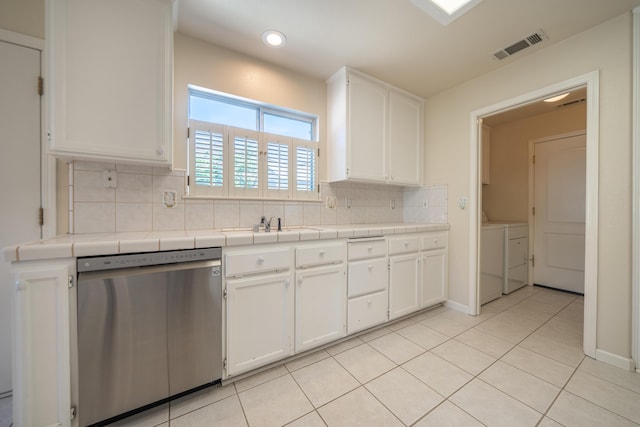 2184 Darsha Ln, Redding, CA 96003 - kitchen featuring stainless steel dishwasher, white cabinetry, backsplash, light tile patterned floors, and tile counters