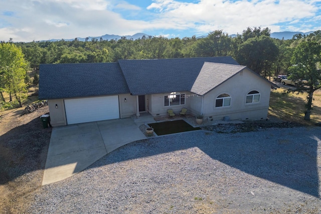 10844 Green Oaks Ln, Redding, CA 96003 - ranch-style house featuring driveway, a garage, stucco siding, a shingled roof, and a mountain view