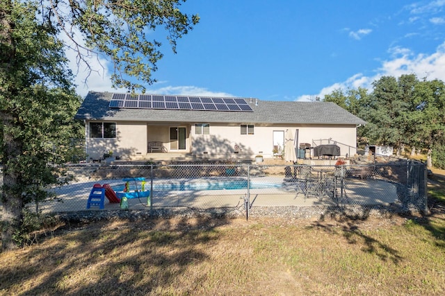 10844 Green Oaks Ln, Redding, CA 96003 - back of house with roof mounted solar panels, a patio area, and stucco siding