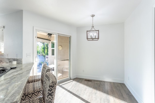 10844 Green Oaks Ln, Redding, CA 96003 - dining space featuring wood finished floors, a chandelier, and baseboards