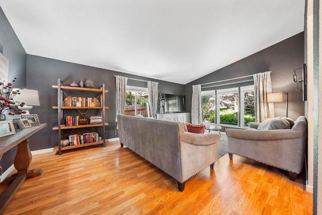 1163 Golden Gate Trl, Redding, CA 96003 - living room featuring lofted ceiling, light wood-style flooring, and baseboards