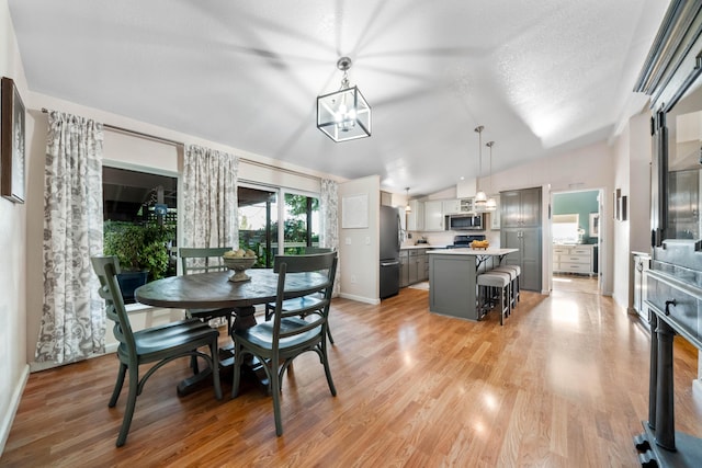 1163 Golden Gate Trl, Redding, CA 96003 - dining space featuring lofted ceiling, light wood-style floors, and baseboards