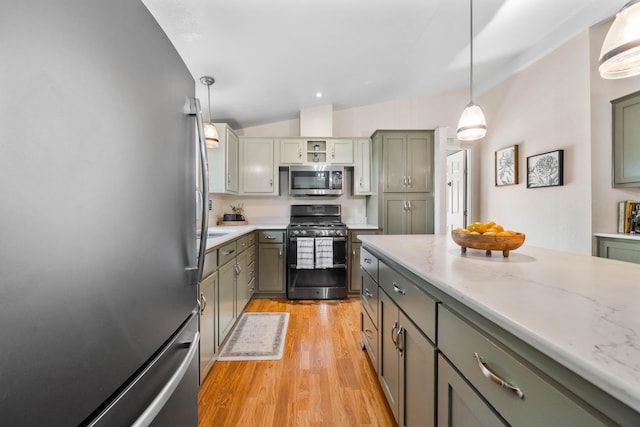 1163 Golden Gate Trl, Redding, CA 96003 - kitchen featuring appliances with stainless steel finishes, lofted ceiling, light wood finished floors, decorative light fixtures, and light stone countertops