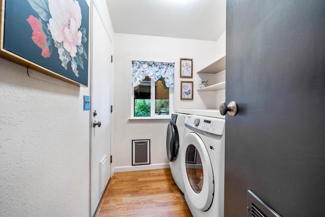 1163 Golden Gate Trl, Redding, CA 96003 - laundry area featuring washing machine and clothes dryer, light wood-style flooring, and baseboards