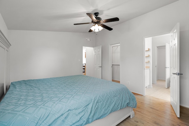 13955 Dusty Oaks Trl, Bella Vista, CA 96008 - bedroom with light wood-style floors, baseboards, a ceiling fan, and a walk in closet