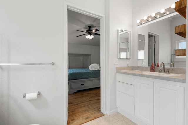 13955 Dusty Oaks Trl, Bella Vista, CA 96008 - bathroom featuring vanity, a ceiling fan, ensuite bath, wood finished floors, and baseboards