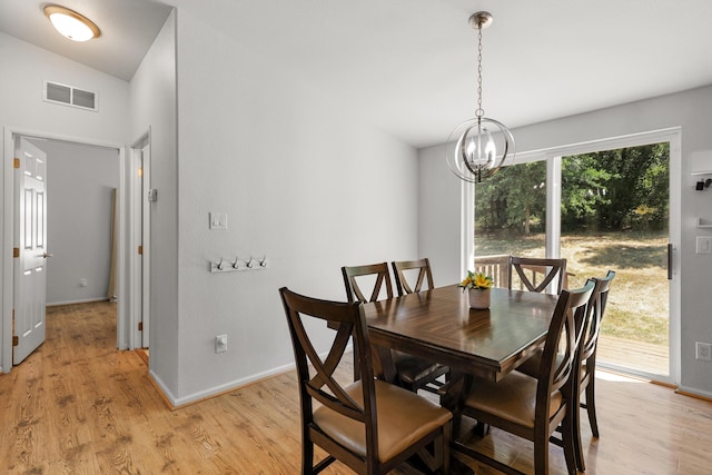 13955 Dusty Oaks Trl, Bella Vista, CA 96008 - dining area featuring a chandelier, light wood finished floors, and baseboards