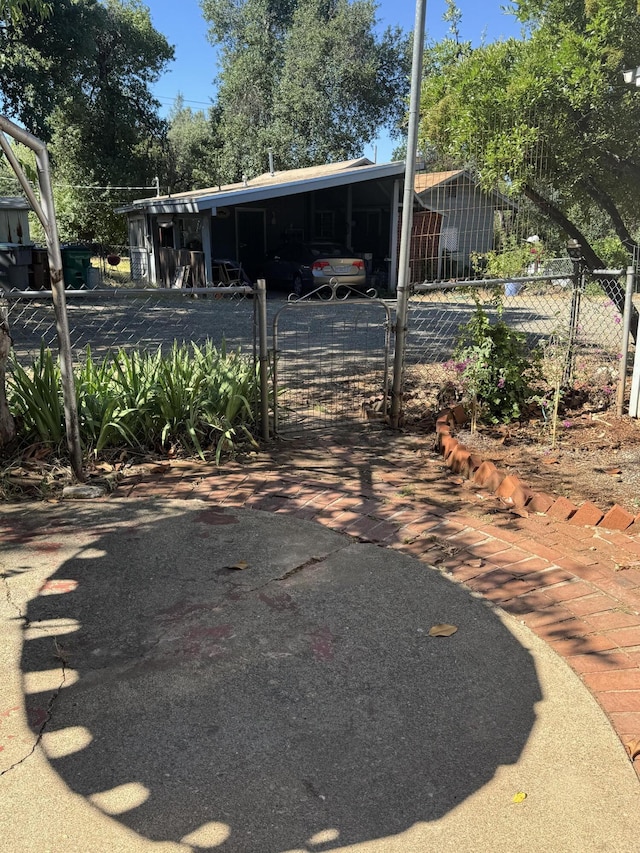 1717 Deer Creek Rd, Shasta Lake, CA 96019 - view of car parking featuring an attached carport, a gate, and driveway