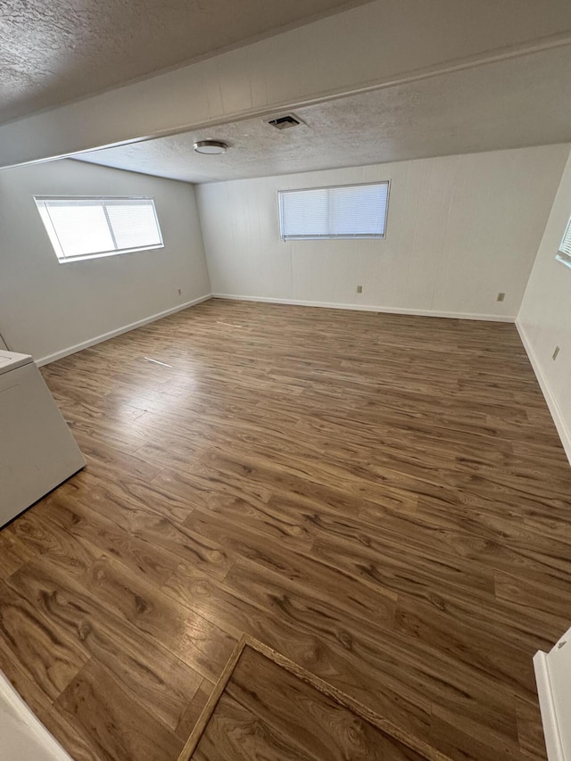 1717 Deer Creek Rd, Shasta Lake, CA 96019 - additional living space with a textured ceiling, wood finished floors, baseboards, and plenty of natural light