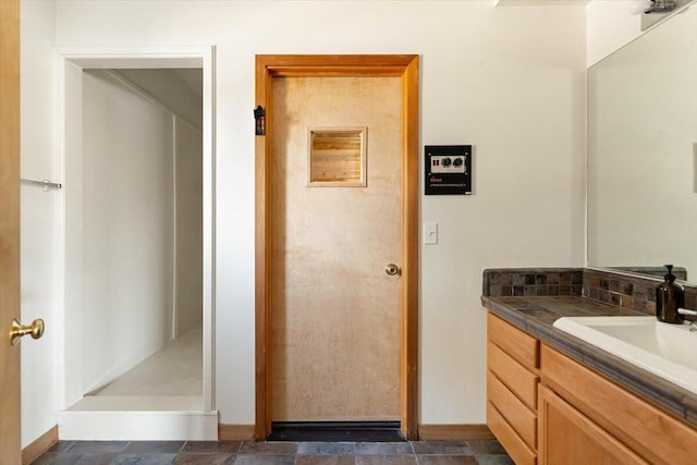 4740 Rainbow, Weed, CA 96094 - full bathroom with vanity, baseboards, walk in shower, stone finish flooring, and tasteful backsplash