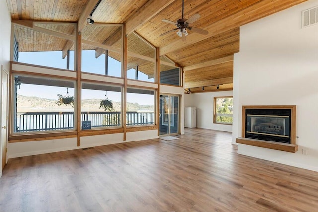 4740 Rainbow, Weed, CA 96094 - unfurnished living room featuring high vaulted ceiling, wood finished floors, wood ceiling with exposed beams, a glass covered fireplace, and ceiling fan
