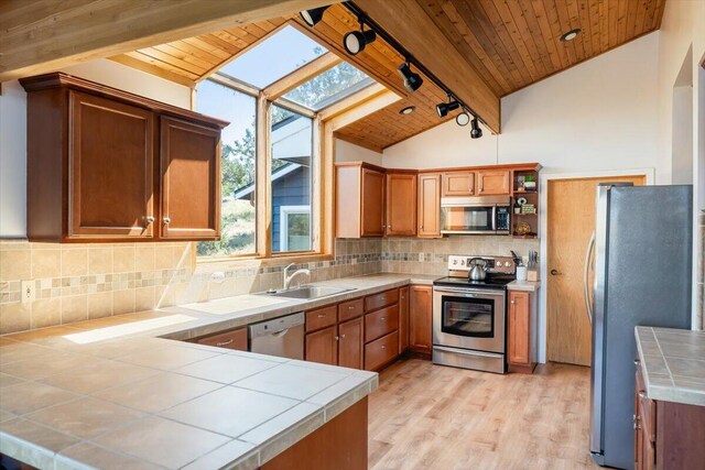 4740 Rainbow, Weed, CA 96094 - kitchen with stainless steel appliances, a sink, track lighting, wood ceiling, and tile countertops