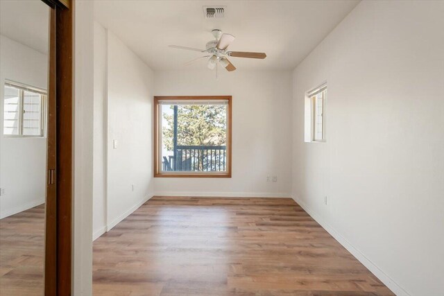 4740 Rainbow, Weed, CA 96094 - unfurnished room with ceiling fan, plenty of natural light, wood finished floors, and baseboards