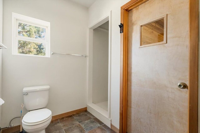 4740 Rainbow, Weed, CA 96094 - full bath featuring stone finish flooring, baseboards, toilet, and a shower