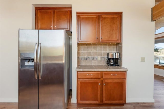 4740 Rainbow, Weed, CA 96094 - kitchen with stainless steel fridge with ice dispenser, tile counters, baseboards, and tasteful backsplash