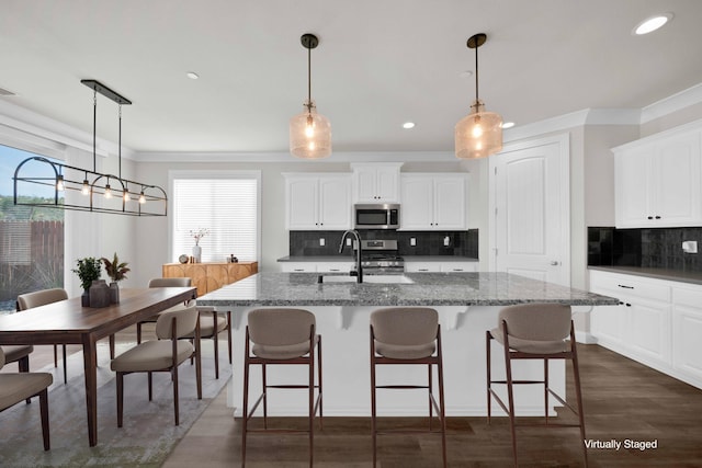 4771 Lower Springs Rd, Redding, CA 96001 - kitchen with appliances with stainless steel finishes, a sink, healthy amount of natural light, crown molding, and decorative backsplash
