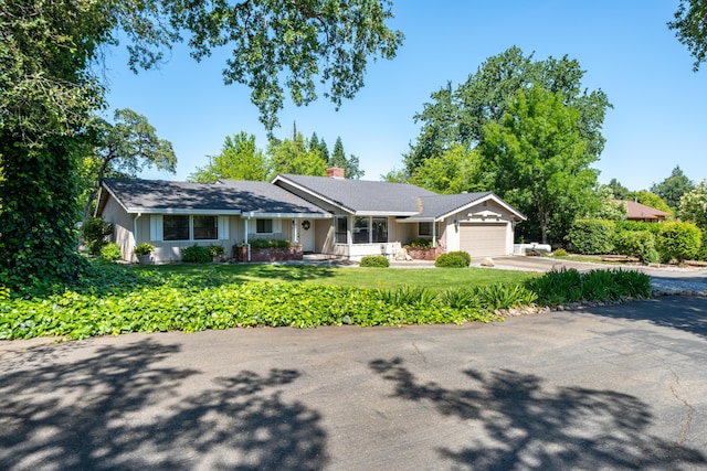 19991 Paso Robles Ave, Redding, CA 96003 - ranch-style house featuring a garage, concrete driveway, a front lawn, and a chimney