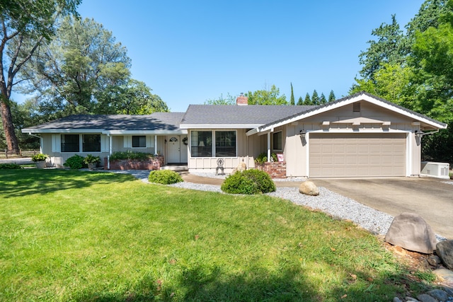 19991 Paso Robles Ave, Redding, CA 96003 - ranch-style home featuring an attached garage, board and batten siding, a chimney, concrete driveway, and a front yard