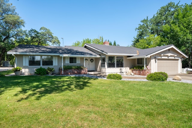 19991 Paso Robles Ave, Redding, CA 96003 - ranch-style home with board and batten siding, an attached garage, a chimney, and a front yard