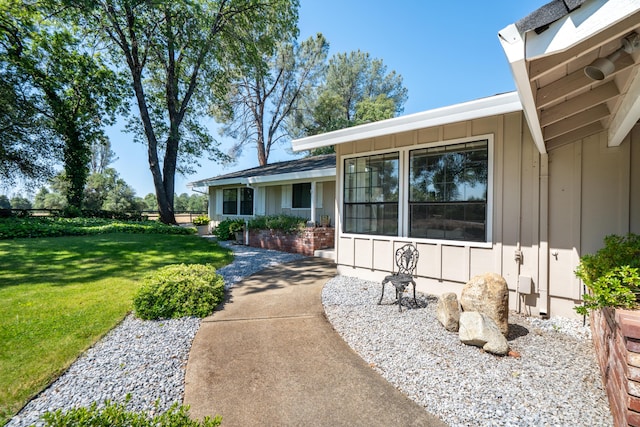 19991 Paso Robles Ave, Redding, CA 96003 - entrance to property with board and batten siding and a yard