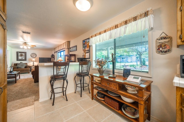 19991 Paso Robles Ave, Redding, CA 96003 - kitchen featuring a kitchen bar, a peninsula, baseboards, tile counters, and a ceiling fan
