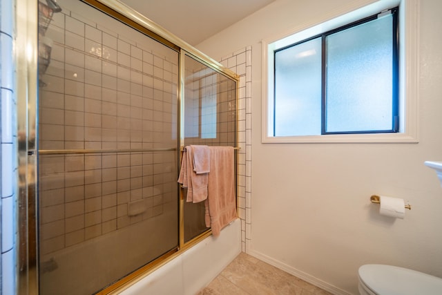 19991 Paso Robles Ave, Redding, CA 96003 - full bath with combined bath / shower with glass door, toilet, tile patterned flooring, and baseboards