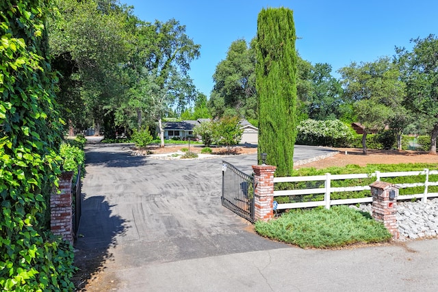 19991 Paso Robles Ave, Redding, CA 96003 - view of asphalt driveway with a gate and a gated entry