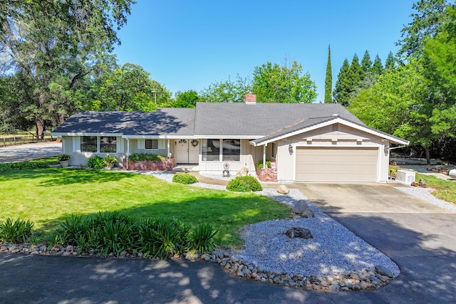 19991 Paso Robles Ave, Redding, CA 96003 - ranch-style home with a chimney, asphalt driveway, a front yard, a garage, and a shingled roof