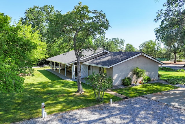 19991 Paso Robles Ave, Redding, CA 96003 - view of home's exterior featuring a lawn, stucco siding, and a shingled roof
