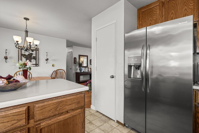 3608 Capricorn Way, Redding, CA 96002 - kitchen featuring stainless steel fridge with ice dispenser, brown cabinetry, a chandelier, light countertops, and decorative light fixtures