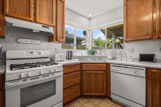 3608 Capricorn Way, Redding, CA 96002 - kitchen featuring white appliances, under cabinet range hood, a sink, light countertops, and a textured wall