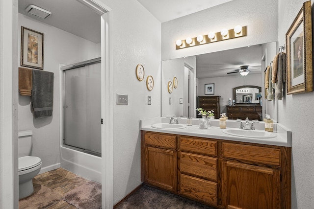 3608 Capricorn Way, Redding, CA 96002 - bathroom featuring toilet, a ceiling fan, double vanity, baseboards, and a textured wall
